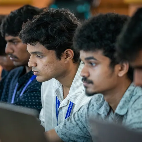 Students working on laptops at a coding event