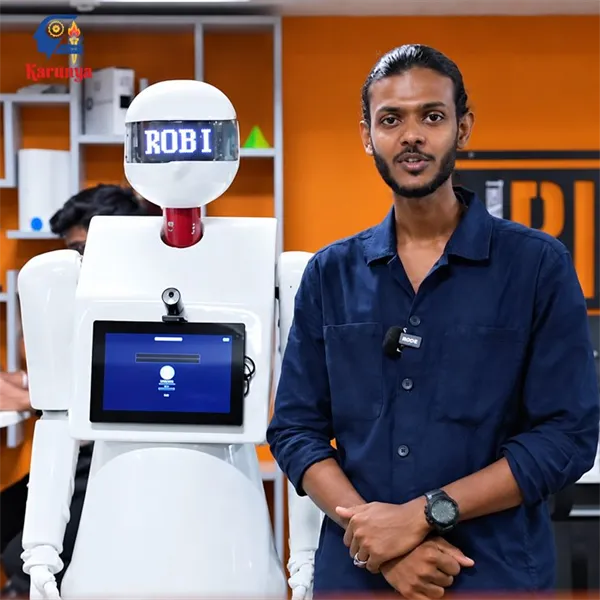 Student standing beside the ROBI humanoid service robot